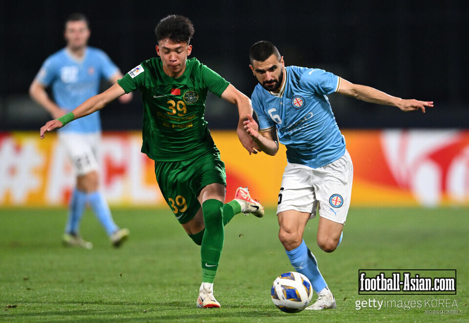 MELBOURNE, AUSTRALIA - DECEMBER 12: Aziz Behich of Melbourne City controls the ball infront of Wang Yudong of Zhejiang FC during the AFC Champions League Group H match between Melbourne City and Zhejiang FC at Princes Park on December 12, 2023 in Melbourne, Australia. (Photo by Quinn Rooney/Getty Images)
