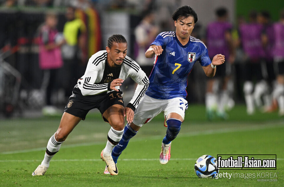 WOLFSBURG, GERMANY - SEPTEMBER 09: Leroy Sane of Germany is challenged by Kaoru Mitoma of Japan during the international friendly match between Germany and Japan at Volkswagen Arena on September 09, 2023 in Wolfsburg, Germany. (Photo by Stuart Franklin/Getty Images)