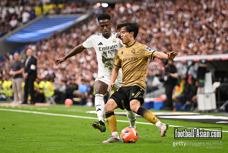 MADRID, SPAIN - MAY 24: Vinicius Junior of Real Madrid challenges Takefusa Kubo of Real Sociedad during the LaLiga match between Real Madrid CF and Real Sociedad at Estadio Santiago Bernabeu on May 24, 2025 in Madrid, Spain. (Photo by Denis Doyle/Getty Images)
