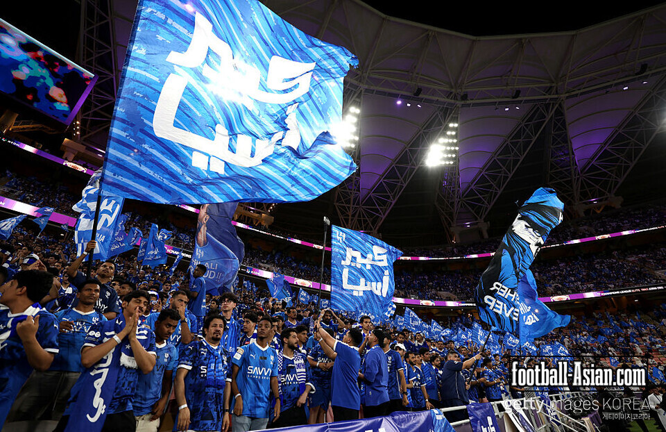 JEDDAH, SAUDI ARABIA - APRIL 29: Al Hilal fans wave flags in support prior to the AFC Champions League Elite Semi Final between Al Hilal and Al Ahli at King Abdullah Sports City Hall Stadium on April 29, 2025 in Jeddah, Saudi Arabia. (Photo by Yasser Bakhsh/Getty Images)