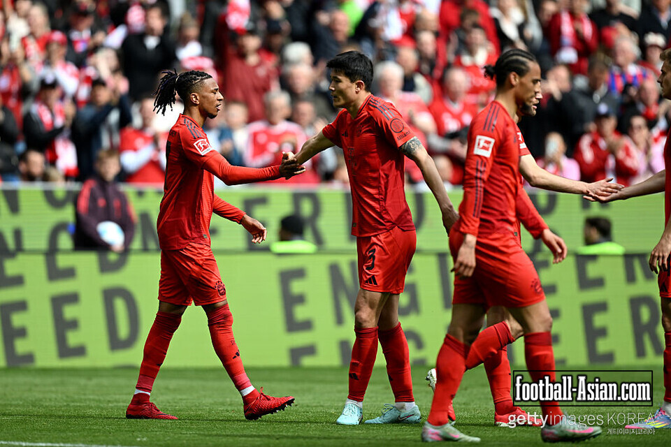 MUNICH, GERMANY - APRIL 26: Michael Olise of Bayern Munich celebrates scoring his team's second goal with teammate Kim Min-Jae during the Bundesliga match between FC Bayern München and 1. FSV Mainz 05 at Allianz Arena on April 26, 2025 in Munich, Germany. (Photo by Christian Kaspar-Bartke/Getty Images)