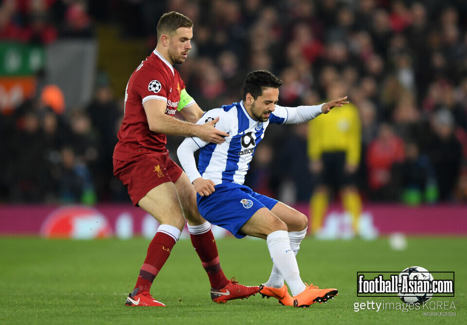 LIVERPOOL, ENGLAND - MARCH 06: Bruno Xavier Almeida Costa of FC Porto is challenged by Jordan Henderson of Liverpool during the UEFA Champions League Round of 16 Second Leg match between Liverpool and FC Porto at Anfield on March 6, 2018 in Liverpool, United Kingdom. (Photo by Shaun Botterill/Getty Images)