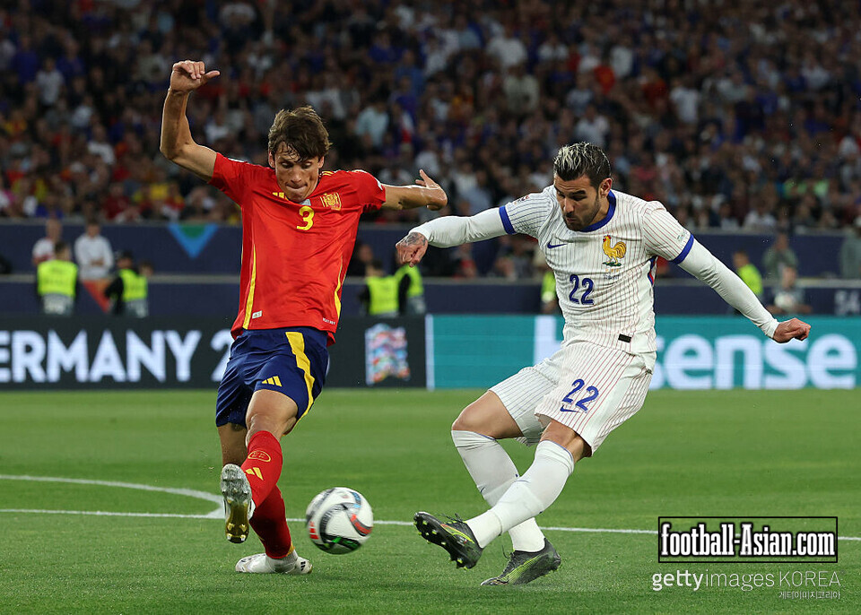 STUTTGART, GERMANY - JUNE 05: Theo Hernandez of France shoots whilst under pressure from Robin Le Normand of Spain during the UEFA Nations League 2025 semifinal match between Spain and France at Stuttgart Arena on June 05, 2025 in Stuttgart, Germany. (Photo by Alexander Hassenstein/Getty Images)