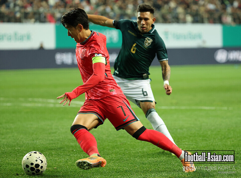 DAEJEON, SOUTH KOREA - NOVEMBER 14: Son Heung Min of South Korea (L) goes past Hector Cuellar of Bolivia (R) during the international friendly match between South Korea and Bolivia at Daejeon World Cup Stadium on November 14, 2025 in Daejeon, South Korea. (Photo by Chung Sung-Jun/Getty Images)